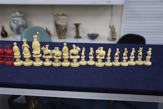 An early 19th century Chinese red stained and natural ivory rosette type chess set, kings 3.25in.